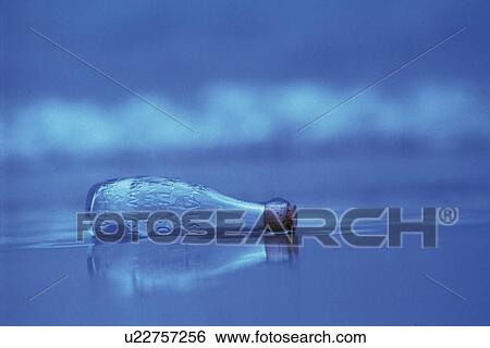 A Glass Bottle Laying on the Beach, Differential Focus View Large Photo Image Stock Photograph - A Glass Bottle Laying on the Beach, Differential Focus. Fotosearch