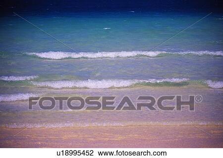 Stock Image - Gentle Waves of the Tropical Beach. Fotosearch