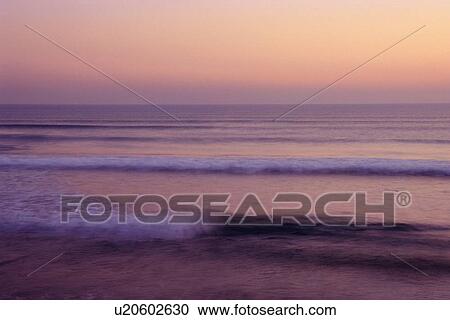 Stock Image - Ocean Waves of Evening Beach, Long Exposure. Fotosearch