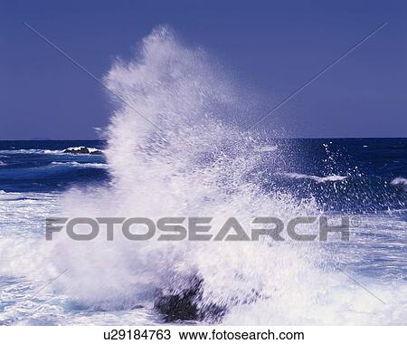 Stock Image - The Waves Breaking on the Rocks. Fotosearch