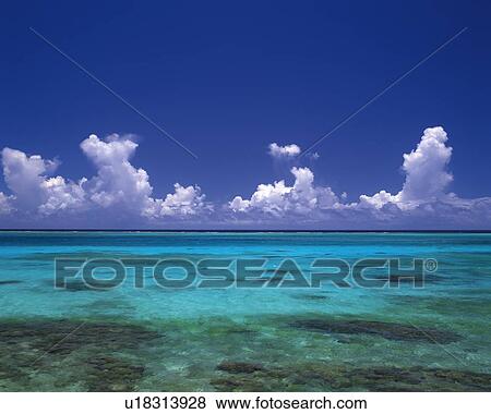 Stock Photo - Tropical Ocean and the Clouds Sailing in the Blue Sky, Pan Focus. Fotosearch