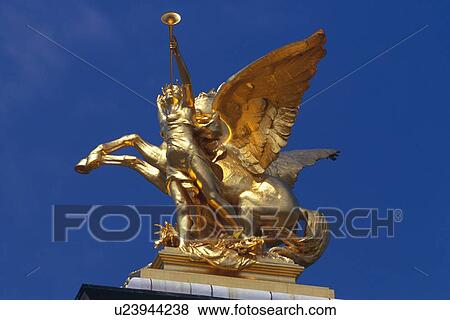 Stock Photo - Image of a Golden Statue Under a Blue Sky, Low Angle View, Side View, Paris, France. Fotosearch
