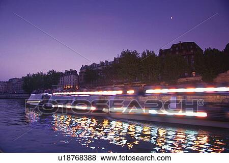 Image of a Tourist Boat on the Seine in the Evening, Side View, Blurred Motion, Long Exposure, Paris, France View Large Photo Image Stock Photo - Image of a Tourist Boat on the Seine in the Evening, Side View, Blurred Motion, Long Exposure, Paris, France. Fotosearch
