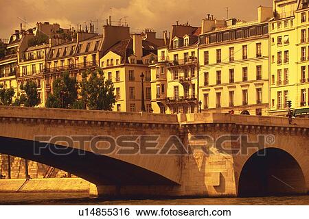 Stock Photograph - Image of Several Apartment houses and a Bridge Right Next to the Seine, Low Angle View, Side View, Paris, France. Fotosearch