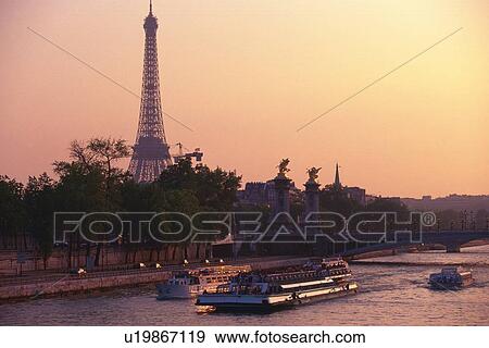 Stock Photo - Image of Several Boats on the Seine by Sunset, the Eiffel Tower in the Background, Side View, Paris, France. Fotosearch