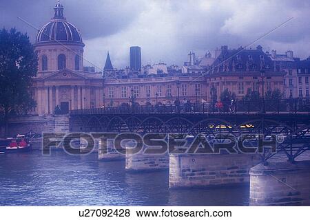 Stock Photo - Image of the Bridge of the Arts and a Huge Building in the Background on a Foggy Day, Side View, Paris France. Fotosearch
