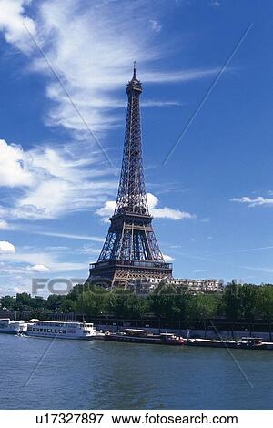 Stock Photo - Image of the Eiffel Tower On a Sunny Day, the Seine on the Side, Side View, Paris, France. Fotosearch