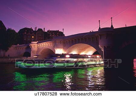 Stock Photo - Image of the Seine and a Bridge, a Tourist Boat Under it, Side View, Blurred Motion, Paris, France. Fotosearch