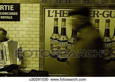 Stock Image - Closed Up Image of a Man Passing By a French Poster, Side View, Blurred Motion, Side View, Paris, France. Fotosearch