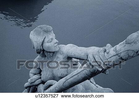 Stock Photo - Closed Up Image of a Statue Made of Stone Over the Seine, High Angle View, Paris, France. Fotosearch