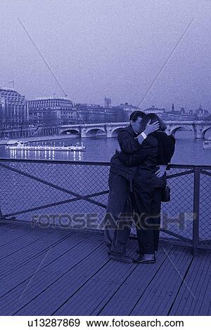 Stock Photo - Image of a Couple Hugging Each Other on a Bridge at the Seine, Side View, Paris, France. Fotosearch
