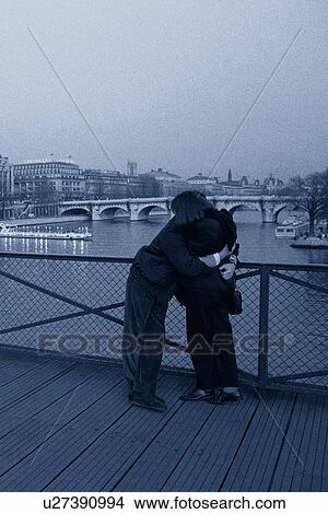 Image of a Couple Hugging on a Bridge Near the Seine, Side View, Paris, France View Large Photo Image Picture - Image of a Couple Hugging on a Bridge Near the Seine, Side View, Paris, France. Fotosearch