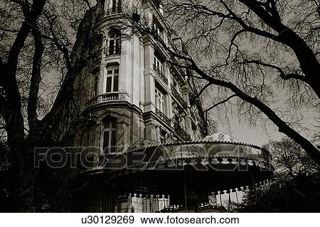 Stock Photo - Image of a Parisian Apartment House and a Carousel In Front of It, Low Angle View, Paris, France. Fotosearch