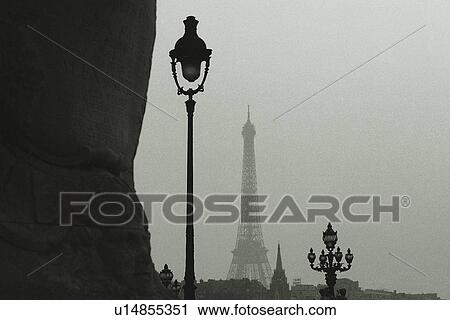 Stock Image - Image of Several Street Lamps and the Eiffel Tower in the Background, Low Angle View, Paris, France. Fotosearch