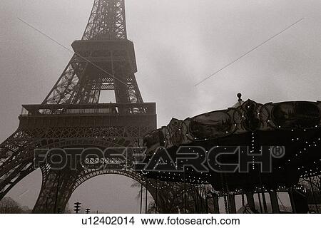 Image of the Eiffel Tower and a Carousel Under a Grey Sky, Low Angle View, Paris, France View Large Photo Image Picture - Image of the Eiffel Tower and a Carousel Under a Grey Sky, Low Angle View, Paris, France. Fotosearch