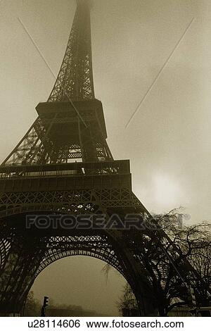 Image of the Eiffel Tower Under a Floggy Sky, Low Angle View, Paris, France View Large Photo Image Stock Photograph - Image of the Eiffel Tower Under a Floggy Sky, Low Angle View, Paris, France. Fotosearch