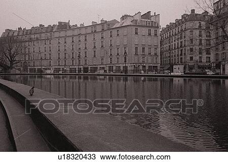 Stock Image - Image of Two Parisian Apartment Houses Next to the Seine, Front View, Paris, France. Fotosearch