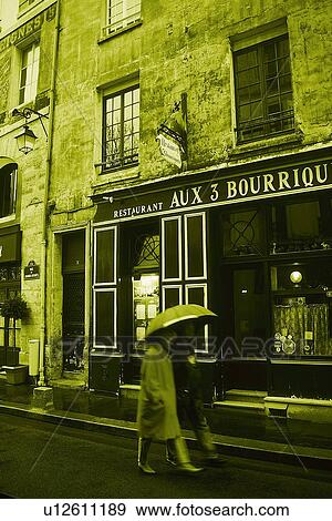 Image of Two People With an Umbrella Walking in the Streets of Paris, Side View, Toned Image, Paris, France View Large Photo Image Stock Photo - Image of Two People With an Umbrella Walking in the Streets of Paris, Side View, Toned Image, Paris, France. Fotosearch