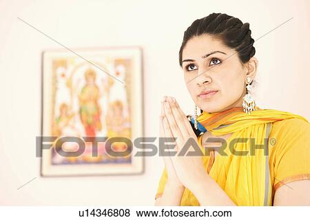 Close-up of a young woman in a prayer position View Large Photo Image Stock Photo - Close-up of a young woman in a prayer position. Fotosearch