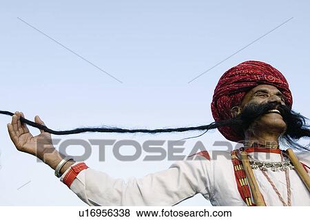 Low angle view of a mature man holding his mustache, Elephant Festival, Jaipur, Rajasthan, India View Large Photo Image Stock Photo - Low angle view of a mature man holding his mustache, Elephant Festival, Jaipur, Rajasthan, India. Fotosearch