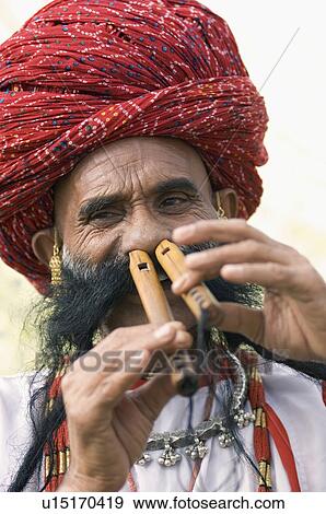 Portrait of a mature man playing two flutes with his nose, Jaipur, Rajasthan, India View Large Photo Image Stock Photo - Portrait of a mature man playing two flutes with his nose, Jaipur, Rajasthan, India. Fotosearch