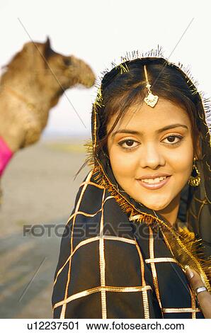 Stock Image - Portrait of a young woman smiling. Fotosearch
