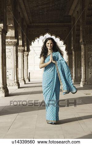 Portrait of a young woman standing in a prayer position View Large Photo Image Stock Image - Portrait of a young woman standing in a prayer position. Fotosearch