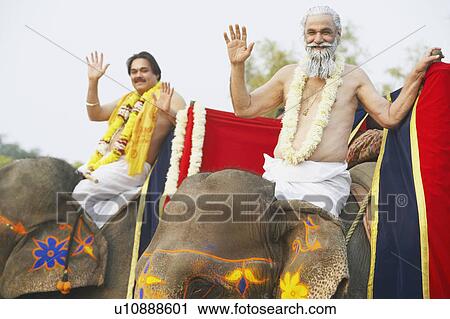 Portrait of two priests riding elephants View Large Photo Image Stock Image - Portrait of two priests riding elephants. Fotosearch