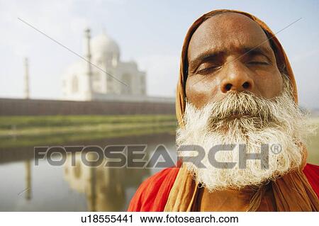 Close-up of a priest meditating on the riverbank with his eyes closed, Taj Mahal, Agra, Uttar Pradesh, India View Large Photo Image Stock Image - Close-up of a priest meditating on the riverbank with his eyes closed, Taj Mahal, Agra, Uttar Pradesh, India. Fotosearch