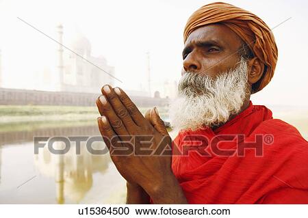 Close-up of a priest standing in a prayer position on the riverbank, Taj Mahal, Agra, Uttar Pradesh, India View Large Photo Image Stock Image - Close-up of a priest standing in a prayer position on the riverbank, Taj Mahal, Agra, Uttar Pradesh, India. Fotosearch