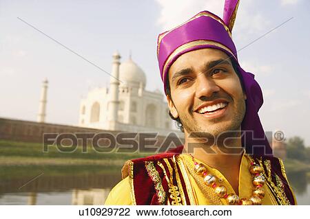 Close-up of a young man smiling in front of a mausoleum, Taj Mahal, Agra, Uttar Pradesh, India View Large Photo Image Stock Image - Close-up of a young man smiling in front of a mausoleum, Taj Mahal, Agra, Uttar Pradesh, India. Fotosearch
