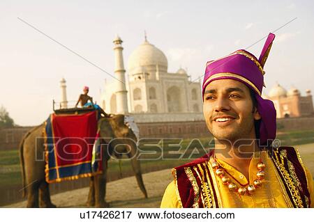 Stock Photo - Close-up of a young man standing at the riverbank, Taj Mahal, Agra, Uttar Pradesh, India. Fotosearch