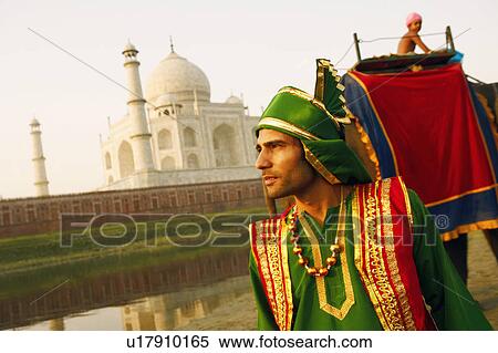Close-up of a young man standing at the riverbank, Taj Mahal, Agra, Uttar Pradesh, India View Large Photo Image Stock Photography - Close-up of a young man standing at the riverbank, Taj Mahal, Agra, Uttar Pradesh, India. Fotosearch
