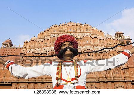 Low angle view of a mature man holding his mustache in front of a palace, Hawa Mahal, Jaipur, Rajasthan, India View Large Photo Image Stock Photograph - Low angle view of a mature man holding his mustache in front of a palace, Hawa Mahal, Jaipur, Rajasthan, India. Fotosearch