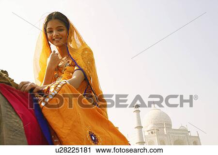 Low angle view of a young woman smiling, Taj Mahal, Agra, Uttar Pradesh, India View Large Photo Image Stock Image - Low angle view of a young woman smiling, Taj Mahal, Agra, Uttar Pradesh, India. Fotosearch