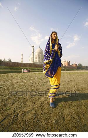 Low angle view of a young woman walking on the riverbank, Taj Mahal, Agra, Uttar Pradesh, India View Large Photo Image Stock Photo - Low angle view of a young woman walking on the riverbank, Taj Mahal, Agra, Uttar Pradesh, India. Fotosearch