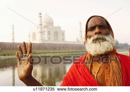 Stock Photography - Portrait of a priest standing on the riverbank, Taj Mahal, Agra, Uttar Pradesh, India. Fotosearch