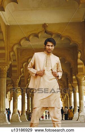 Stock Photo - Portrait of a young man standing, Agra Fort, Agra, Uttar Pradesh, India. Fotosearch