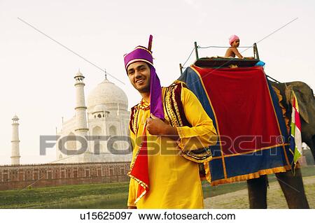 Stock Photo - Portrait of a young man standing on the riverbank, Taj Mahal, Agra, Uttar Pradesh, India. Fotosearch