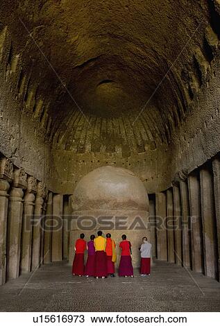 Rear view of Monks praying in front of a sculpture, Kanari Cave, Mumbai, Maharashtra, India View Large Photo Image Stock Image - Rear view of Monks praying in front of a sculpture, Kanari Cave, Mumbai, Maharashtra, India. Fotosearch