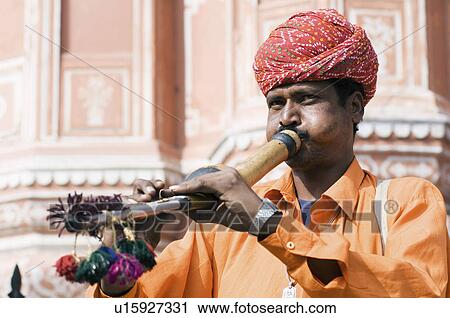 Snake charmer playing a flute in front of a palace, Hawa Mahal, Jaipur, Rajasthan, India View Large Photo Image Stock Image - Snake charmer playing a flute in front of a palace, Hawa Mahal, Jaipur, Rajasthan, India. Fotosearch