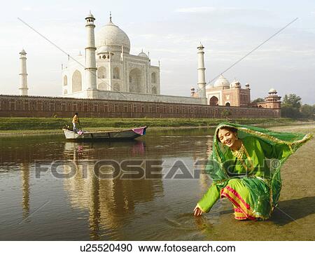 Young woman crouching on the riverbank, Taj Mahal, Agra, Uttar Pradesh, India View Large Photo Image Stock Image - Young woman crouching on the riverbank, Taj Mahal, Agra, Uttar Pradesh, India. Fotosearch