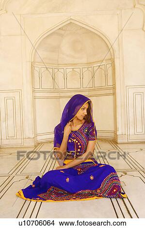 Young woman sitting on the floor View Large Photo Image Picture - Young woman sitting on the floor. Fotosearch