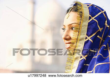 Close-up of a young woman smiling in front of a mausoleum, Taj Mahal, Agra, Uttar Pradesh, India View Large Photo Image Stock Photo - Close-up of a young woman smiling in front of a mausoleum, Taj Mahal, Agra, Uttar Pradesh, India. Fotosearch