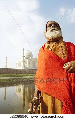 Low angle view of a priest standing at the riverbank, Taj Mahal, Agra, Uttar Pradesh, India View Large Photo Image Stock Image - Low angle view of a priest standing at the riverbank, Taj Mahal, Agra, Uttar Pradesh, India. Fotosearch