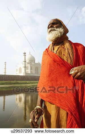 Low angle view of a priest standing at the riverbank, Taj Mahal, Agra, Uttar Pradesh, India View Large Photo Image Stock Image - Low angle view of a priest standing at the riverbank, Taj Mahal, Agra, Uttar Pradesh, India. Fotosearch