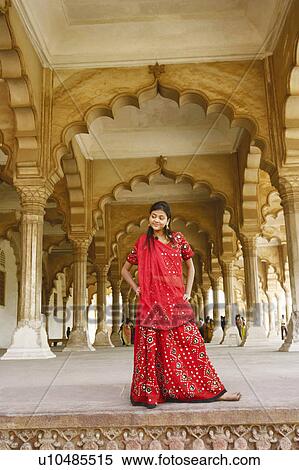 Stock Photography - Low angle view of a young woman standing looking away, Agra Fort, Agra, Uttar Pradesh, India. Fotosearch