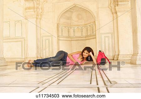 Portrait of a young woman lying on the floor View Large Photo Image Stock Image - Portrait of a young woman lying on the floor. Fotosearch