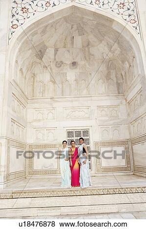 Stock Photo - Portrait of three young women standing in a mausoleum, Taj Mahal, Agra, Uttar Pradesh, India. Fotosearch