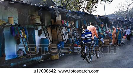 Stock Image - Rear view of two men cycling on the street, Mumbai, Maharashtra, India. Fotosearch